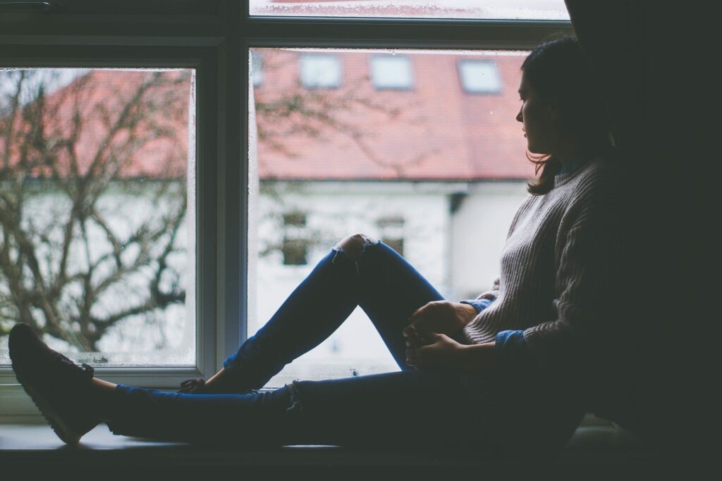 Active Reasoning Exercise - woman sitting in window looking at the world